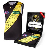 A signed Richmond Tigers 2025 squad guernsey, officially licensed by the AFL, displayed in a deluxe presentation box with a custom-designed insert featuring the full squad photo and player list. Comes with a Certificate of Authenticity, perfect for collectors and fans.