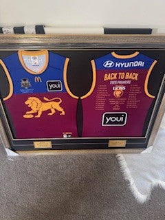 BRISBANE dual signed premiership jumpers by winning coaches Leigh Matthews and Chris Fagan